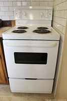 Full front view of white freestanding range in kitchen