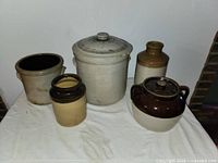 Full view of five clay pots showing their size, shape, and finish variations.