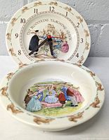 Photo showing the teaching clock with black hour and minute hands, red second hand, and Bunnykins illustration on the clock face, along with the cereal bowl's interior scene with Bunnykins characters.