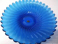 Full view of the cobalt blue glass platter showing petal rim and swirl pattern.