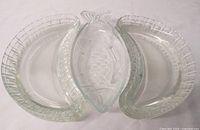 Top view of two crescent-shaped plates and the fish-shaped glass dish