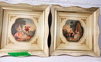 Pair of vintage framed prints "The Music Lesson" and "Innocence" showing overall frames and prints.