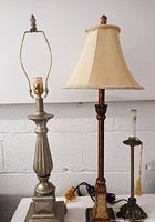Two vintage table lamps and one buffet candlestick lamp displayed side by side, showing the bases, lampshades, and bulb fixtures.