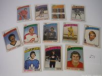 Photo showing twelve 1976 OPC hockey cards in two separate groupings with players from Kings, Penguins, Flames, Maple Leafs, Canadiens, and more.