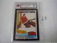 Front side of the 1980-81 O-Pee-Chee Tony Esposito hockey card showing player in Chicago Black Hawks goalie uniform with KSA grading label of 8.5 Near Mint+. Card is in protective rigid case.