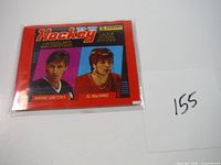 Photo of the unopened 1991-92 Panini hockey card pack showing colorful portraits of Wayne Gretzky and Al MacInnis with the pack sealed in plastic.
