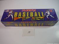 Photo of the sealed purple Fleer 1991 baseball card box with baseball player artwork and yellow text on side.