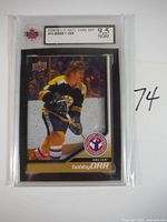 Front of 2008-09 Upper Deck National Card Day #4 Bobby Orr hockey card in graded protective case, showing player in Bruins uniform on the ice.