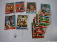 Display of 14 vintage 1974 OPC hockey cards including Billy Smith and Terry O'Reilly cards.