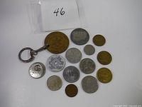 Group of coins, medallions, and tokens including a keychain medallion