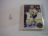 Close-up photo of hockey card showing Mario Lemieux in white uniform with 'C' captain badge and OPC Premier logo