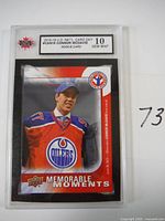 Front of the Connor McDavid rookie card with image of McDavid in Edmonton Oilers jersey and 'Memorable Moments' design.