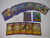 Sixty Digimon trading cards fanned out and displayed, including holographic and character cards.