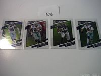 Four Dallas Cowboys player football cards from 2021 Donruss Optic, shown in protective sleeves