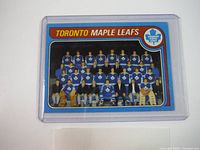 Front of the team photo card showing Toronto Maple Leafs players and staff in team uniforms and suits.