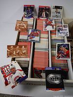 Overall lot of hockey cards arranged in boxes showing a variety of Montreal Canadiens cards from different years and sets.