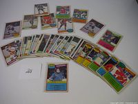 32 hockey cards from 1980 OPC series laid out on white surface, showing various NHL players and teams