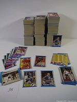 Six large stacks of 1989 OPC hockey cards with loose cards spread around showing various players and backs of cards.