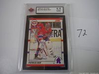 Two photos showing the 1990-91 Score #10 Patrick Roy hockey card graded 9.5 by KSA in plastic holders, with handwritten label '72'.
