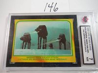 Front of the graded 1980 Topps Star Wars ESB card #333 showing the Imperial Snow Walker attack scene, held in PSA graded case marked NM 7.