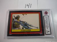 Front side of the graded trading card showing the image of The Deadly Cannon character and the card label with grade 8 from PSA.