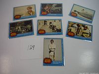 All seven OPC Star Wars trading cards laid out showing front images. Cards show visible wear, creasing, and some discoloration.