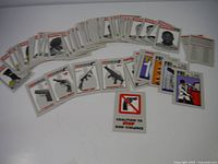 Partial set of around 80 playing cards with images of criminals and firearms
