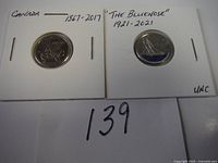 Photo of two Canadian dimes in coin holders, dated 1867-2017 and Bluenose 1921-2021