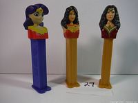 Full front view of three Wonder Woman Pez dispensers in a row on a white background.