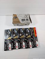 Front view showing 10 blank cassette tapes including Denon HD8 90, Fuji DR 90, and Memorex DR 90 in original packaging.