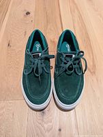 Top view of the pair of green Converse shoes showing laces and upper detail
