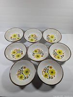 Top-down view of eight Johnson Brothers Honeybunch cereal bowls showing floral design and arrangement