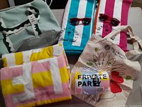 Lot contents showing all towels, sunglasses, and tote bags arranged on surface