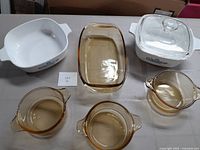 Full set of two CorningWare casseroles, three brown glass bowls, and one brown rectangular glass dish.