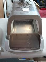 Front view of the Petsafe ScoopFree automatic litter box showing the entry flap and reusable metal tray inside.