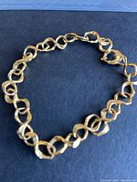 Full view of bracelet laid flat on black surface