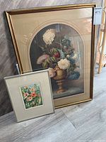 Two framed floral artworks: a large ornate floral print and a smaller colorful watercolor floral painting