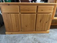 Bottom portion of the buffet cabinet showing drawers and wood doors