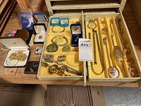 Mixed pieces displayed in open jewelry box and loose on table