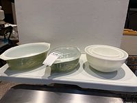 Front view of the Pyrex baking dishes and mixing bowls on a white surface