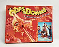 Box front with cartoon firefighter sliding down pole and inset photo of children playing game.