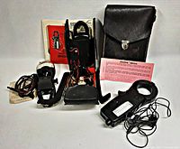 Three amp probes displayed with two carrying cases, manuals, and paperwork on white background.