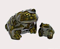 Photo showing both large and small green ceramic frog figurines with shiny glaze on white background