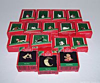 Lot of 16 Hallmark Keepsake miniature Christmas ornaments in original red and green boxes with some wear. Ornaments include various animal and Santa themed items.