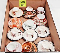 Top-down view of the 11 sets and one single cup in boxed lot