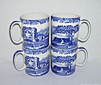 Four Spode Italian Blue and White coffee mugs stacked in two pairs, showing full blue and white Italian scenery pattern.