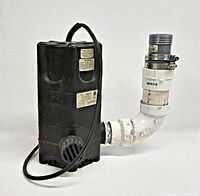 Side view of Little Giant submersible pump with attached PVC pipe and clamps