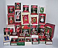 Full lot of 29 vintage Hallmark Christmas ornaments in original boxes, arranged in tiers showing box fronts and sizes.