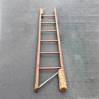 Ladder open showing six rungs and metal support bracket at bottom