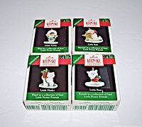 Four Hallmark Keepsake miniature ornaments in original boxes, showing front of boxes with artwork and labeling of the set named Little Frosty Friends.
